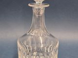 a glass bottle that is sitting on a table