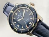 a close up of a wrist watch with a blue strap