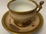 a cup and saucer on a saucer on a white table