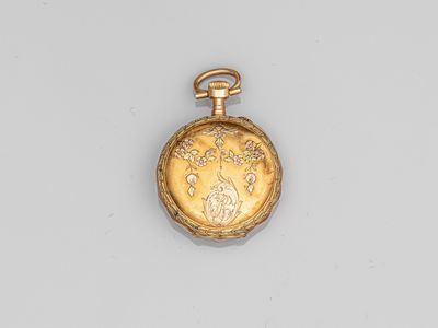 a close up of a gold pocket watch on a white surface