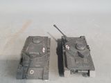 two toy tanks sitting next to each other on the floor