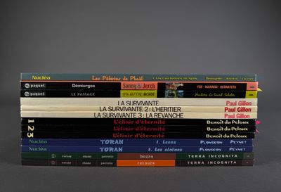 several books are stacked on top of each other on a table