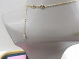 a mannequin with a gold chain and a diamond on it