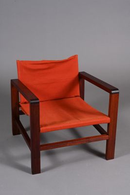 Fauteuil " Safari " en bois rouge, assise et dossier suspend…