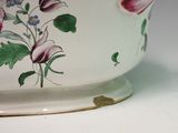 a white bowl with flowers painted on it