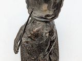 a small statue of a person with a hat on