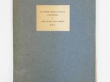 a blue book with a gold plate on top of it