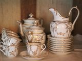 a lot of cups and saucers on a table