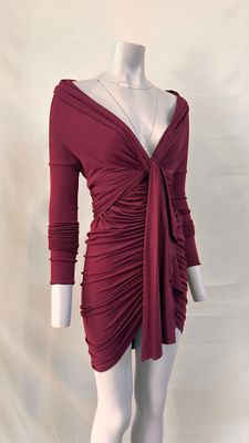 a mannequin wearing a red dress with long sleeves