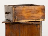 a wooden box with a handle on top of it