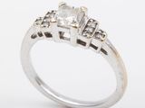 a close up of a diamond ring on a white background