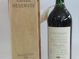 a bottle of wine sitting next to a wooden box