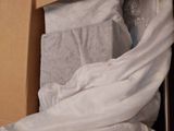 a cat that is sitting in a box under a blanket