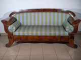 a couch that is sitting on a tiled floor