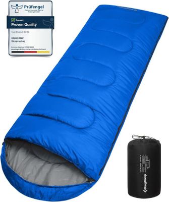 une image représentant un sac de couchage bleu avec un sac noir à côté