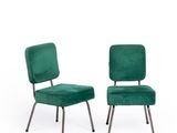 pair of green velvet chairs with metal legs