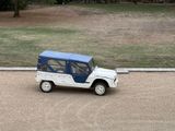 a small blue and white jeep parked in a parking lot