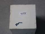 a small white box with a sticker on the side of it