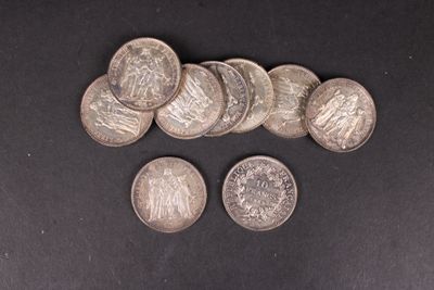 six types différents de pièces d'argent sur une surface noire
