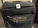 a piece of luggage sitting on the floor with a price tag on it
