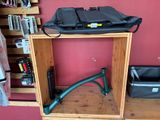 a wooden shelf with a black bag on top of it