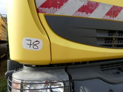 a close up of a yellow truck with a red stripe on it