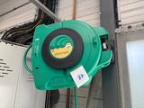 a green blower that is attached to a wall