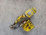 a close up of a yellow and black fire extinguisor on the ground