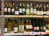many bottles of wine on the shelves in the store