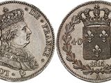 a silver coin with a crown on top of it