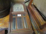 a clock that is sitting on a table next to a chair