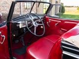 a red and black car with a steering wheel and dashboard
