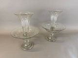 two clear glass vases sitting on a table