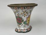 a vase with a floral design on it on a white surface