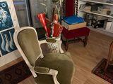 an image of a living room with a chair and bookshelf