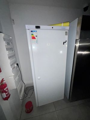 a white refrigerator in the corner of a kitchen