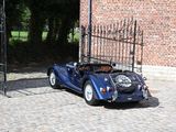a blue car that is parked in front of a gate