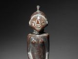 an image of a wooden statue of a man with a face
