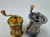 two different types of coffee grinders on a white surface