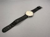an image of a wrist watch on a table with a white background