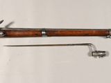 an old gun with a wooden handle and a metal handle