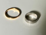 two rings sitting on a table next to each other