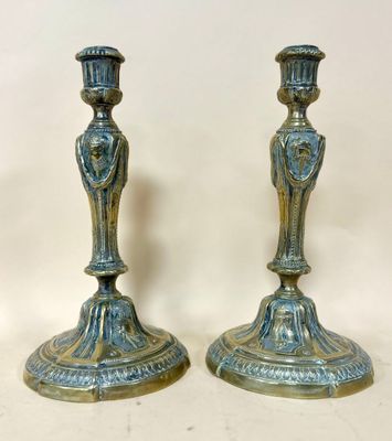 pair of antique brass candlesticks with ornate design