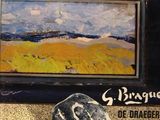 a picture of a painting and a rock on the ground