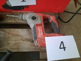 an image of a corded drill is sitting on a wooden table