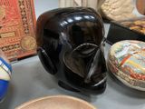 a black elephant statue sitting on a table next to other items