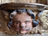 a close up of a statue of a man with a bird on his head