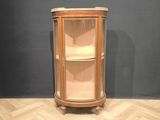 a corner cabinet in the corner of a room