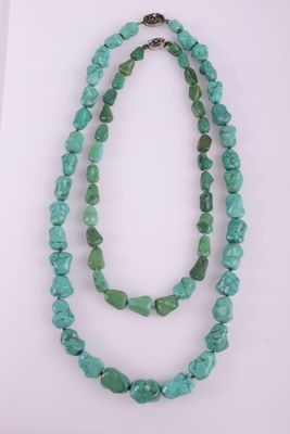 a necklace with two strands of turquoise beads and a silver clasp