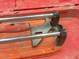 a red tool box with a hammer and a wrench in it